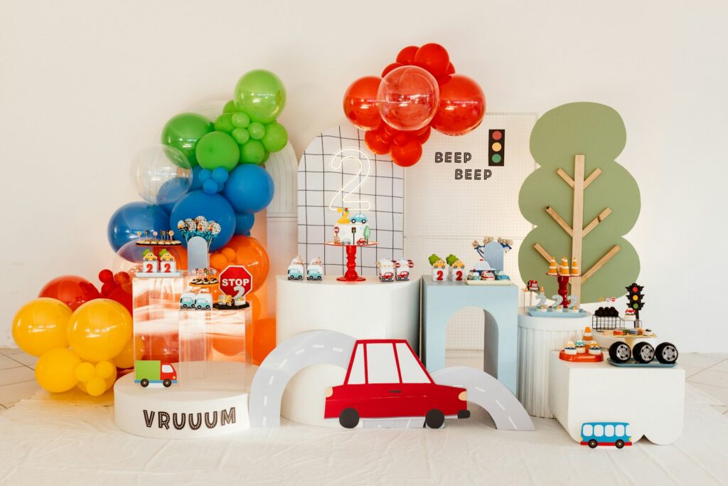 A transportation-themed party has colorful decorations.